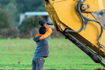 Excavator maintenance and repair operator doing repairs and maintenance