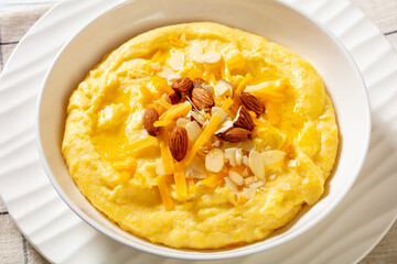 corn grits with butter, vegan cheese, and almonds