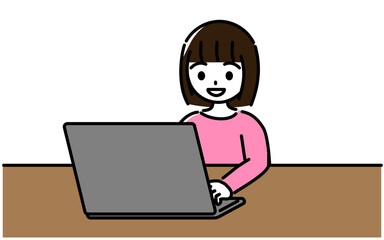 笑顔でノートパソコンを操作する小学生の女の子