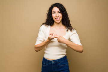 Cheerful woman saying friendship with sign language
