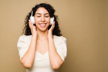 Fototapeta premium Relaxed woman listening happy music with headphones