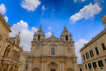 Fototapeta na wymiar Saint Paul and Peter Cathedral in Mdina, Malta. Roman Catholic church under cloudy sky background.