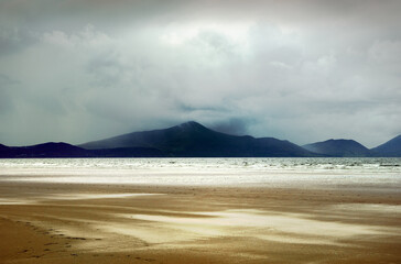 Fototapeta na wymiar Inch Strand, County Kerry, Ireland. Looking south across Dingle Bay toward the mountains of the Ring of Kerry. Stormy weather