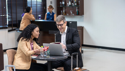 Two business workers are waiting and taking facility service at an exclusive airline lounge....