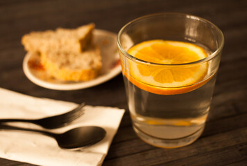 slice of orange in glass of water on the table