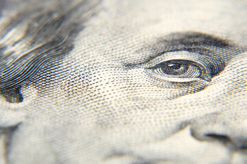 Eyes on face of the Portrait of Benjamin Franklin on 100 dollar banknote, macro,