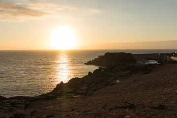 backlit seascape, beautiful golden sunset over the sea from the cliffs. El Cotillo, Fuerteventura, Canary Islands, Spain