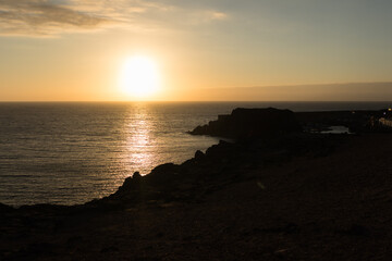 backlit seascape, beautiful golden sunset over the sea from the cliffs. El Cotillo, Fuerteventura, Canary Islands, Spain