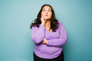 Creative obese woman thinking of a new idea