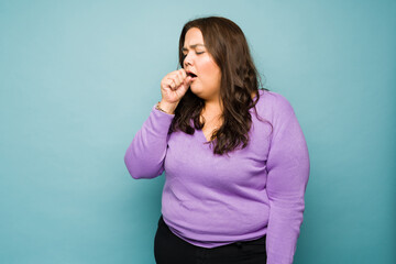 Ill obese woman suffering from a cold and cough