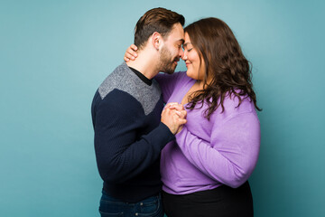 Lovely young couple in love hugging and holding hands