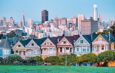 Painted Ladies Victorian houses in Alamo Square and a view of the San Francisco skyline and...