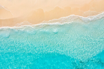 Plakat Summer seascape beautiful waves, blue sea water in sunny day. Top view from drone. Sea aerial view, amazing tropical nature background. Beautiful bright sea waves splashing and beach sand sunset light