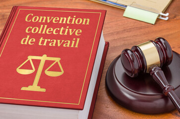 A law book with a gavel - Collective agreement in french - Convention collective de travail