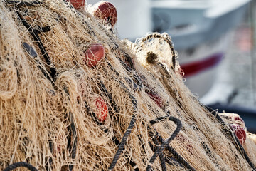 Tangles of fishing nets in a chaotic heap on the edge of a fishing port in Tunisia
