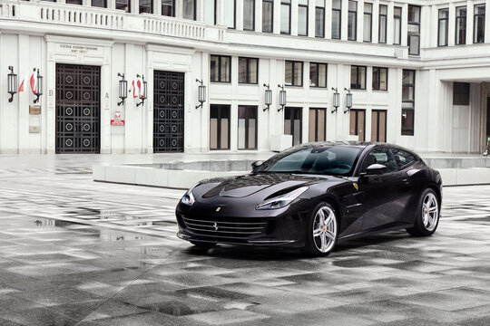 Ferrari GTC4 Lusso In The Courtyard Of The Socialist Realist Building Where Once Was The Seat Of The Socialist Party And Today Is The Stock Exchange. Warsaw, Poland - 13.04.2019