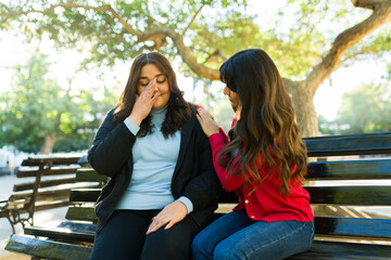 Big woman talking while crying with her best friend