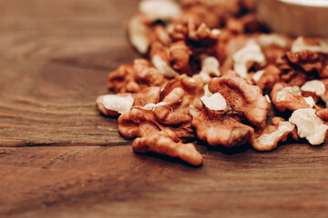 Dried walnut grains scattered on a wooden table.