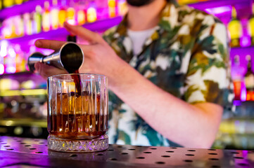 man hand bartender making cocktail in glass on the bar counter