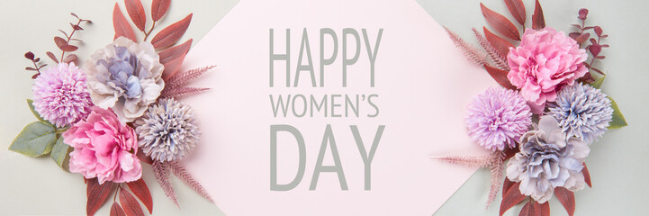 Happy Women's Day Pastel and Muted Tones Banner. Flat lay floral greeting card with beautiful silk flowers.