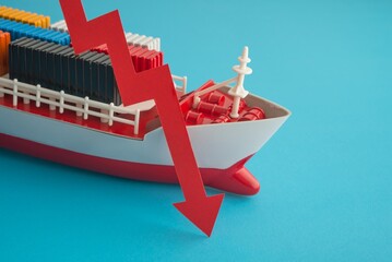 Red economy graph chart falling down collapse with cargo containers ship on sea blue background....