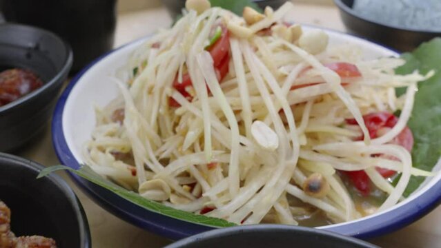 Thai Green Papaya Salad is a spicy salad made from shredded unripe papaya. It was created by the Lao people and is a popular national dish of Laos  and also considered a national dish in Thailand.