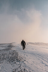 Person climbing a snow covered volcano in Iceland