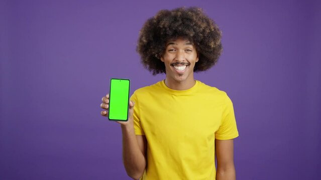 Happy african man holding a mobile with a chroma screen