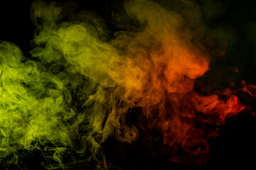 Red yellow green smoke on a black background.