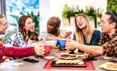 People with dog talking and having fun together at coffee restaurant - Multi racial young friends toasting coffee and doing breakfast in bar bakery shop - Friendship concept