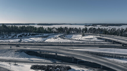 Aerial view of a freeway intersection Snow-covered in winter.Busy intersection. Birds eye view from drone. Cityscape