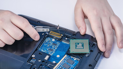 Technician fixing computer. Repair and upgrade concept of laptop. Workshop background