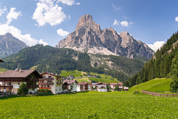 Fototapeta premium Corvara village and Sassongher mountain as seen from the village below, Val Badia, Dolomites, South Tyrol, Italy