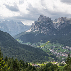 Fototapeta premium Sassongher mountain (2.625 m), standing out from Gerdenacia range, with Sella Group in the background as seen from the high trail to La Villa , Val Badia, Dolomites, South Tyrol, Italy