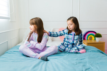 Little kids fighting after playing on a slumber party