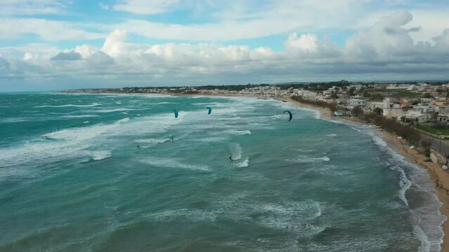 Kate surfing, in Puglia, rough sea, shot from above 11