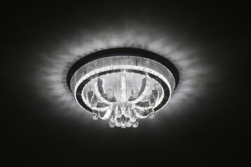 Close up on the crystal of chandelier, a branch pendant light designed to be mounted on the ceiling .