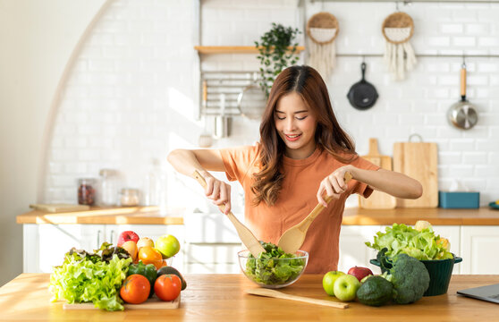 Portrait Of Beauty Body Slim Healthy Asian Woman Having Fun Cooking And Preparing Cooking Vegan Food Healthy Eat With Fresh Vegetable Salad In Kitchen At Home.Diet Concept.Fitness And Healthy Food