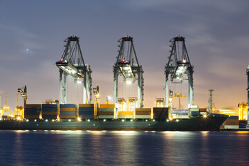 Cargo ship at dock, port or harbor. To loading cargo container, work with crane. Concept of...