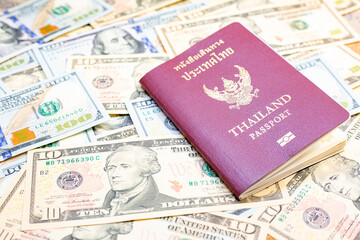 Passport of Thailand on group of money dollars banknotes arranged. Passport on the dollars banknotes chaotic manner. .Exchange money, money, cash, finances,Travel and immigration concept.