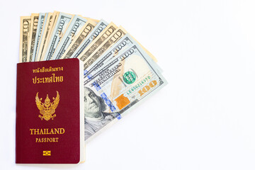 Passport of Thailand and group of money dollars banknotes arranged on white background and space for text. Exchange money, money, cash, finances concept. Travel and immigration concept.