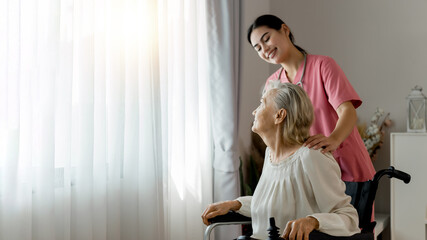 Young professional confident skilled woman doctor visiting old patient lady at home for treatment control care giving. Nurse talking to Caucasian senior patient. Healthcare concept