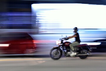 person riding a motorcycle, panning