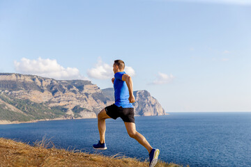 male runner run mountain trail on seashore