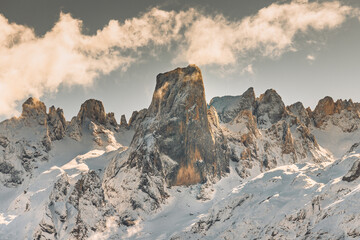 Beautiful snowy mountain landscape at sunset. Close-up view of the Naranjo de Bulnes in the Picos...