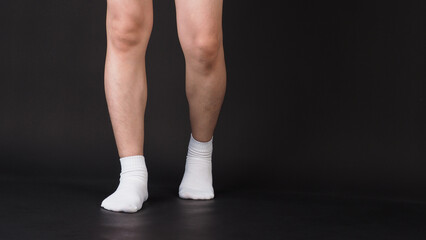 Asian Male split legs wear white sock is isolated on black background