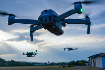 One drone spotting two others in front of a clouded sky and sunset near a German town