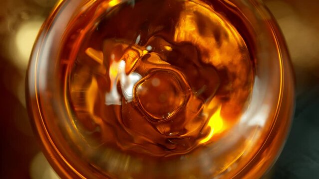 Super Slow Motion Detail Shot of Drop Falling into Glass with Rum at 1000fps.