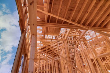 Newly constructed stick house will require constructing wooden roof rafters timber beams from framework trusses