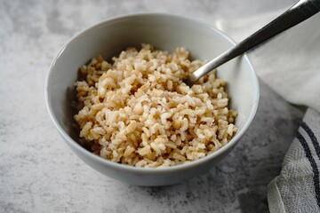 Cooked brown rice served in a bowl, selective focus